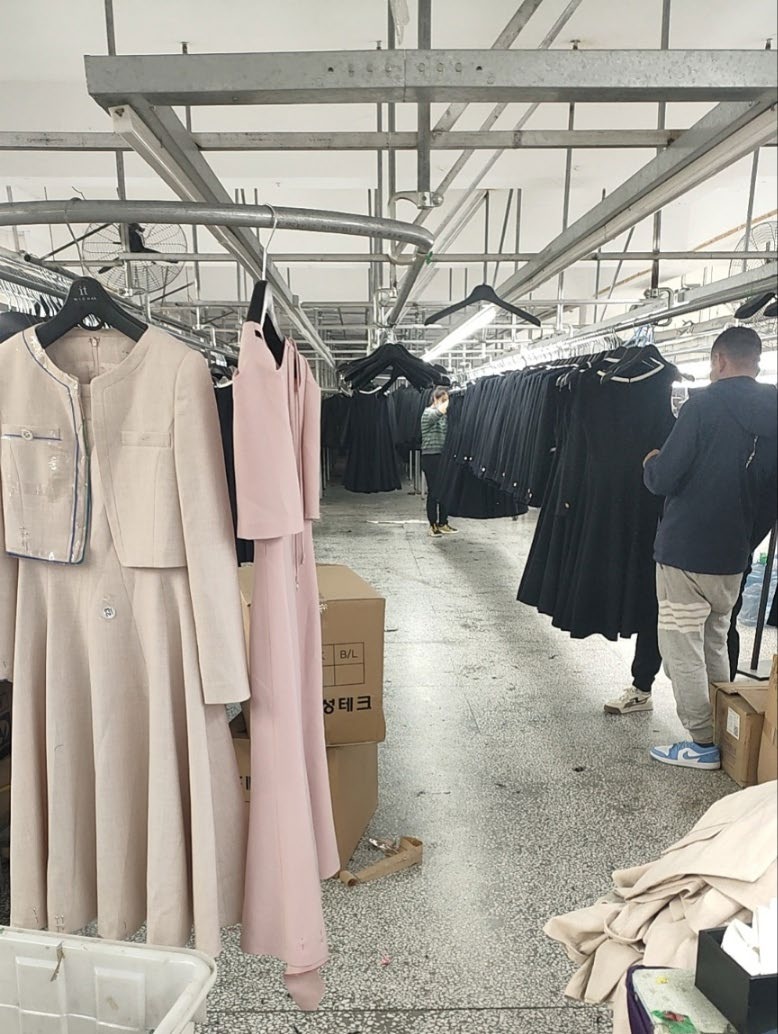 Finished garments on racks in Dalian